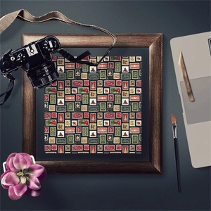 Close-up of vintage Christmas stamp patterns with Noel and Joy lettering on decorative paper