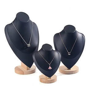 Three-piece matte black necklace bust set with solid wood bases for jewelry display