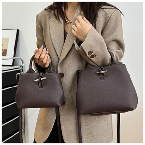 Detailed comparison of large and small dark brown leather bucket bags with bamboo toggles