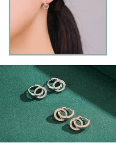Close-up of interlocking S925 silver and rose gold hoop earrings with sparkling stones