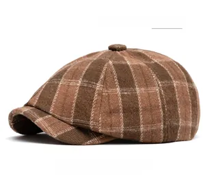 Close-up of retro British newsboy cap featuring thick coffee colored grid wool fabric