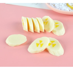 Close-up of realistic PVC banana slice keychain accessory with detailed fruit textures