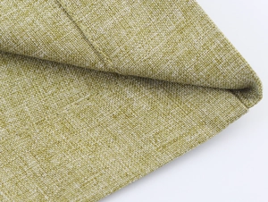 Close-up of the woven linen texture and breathable green fabric of the two-piece suit