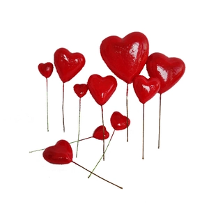 Glossy red heart cake toppers in various sizes for DIY flower and festive decorations