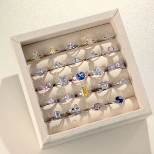 Collection of S925 sterling silver rings with colorful stones in a jewelry box