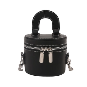 Minimalist black bucket bag with white contrast stitching and silver double zippers