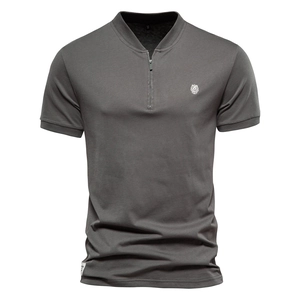 Detail of dark grey cotton polo shirt showing metal zipper neck and lion head embroidery