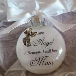 Memorial feather ornament with Mom tribute text, ribbon bow, and angel charm detail