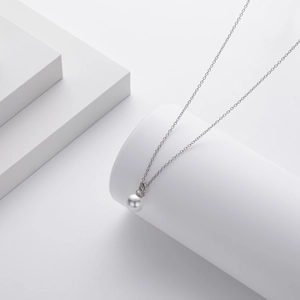 Minimalist 925 sterling silver pearl necklace on white geometric display stand