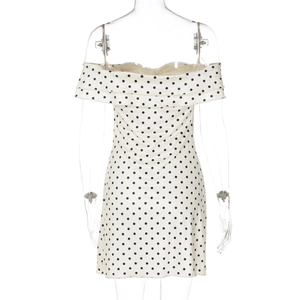 Detail of polka dot strapless mini dress featuring ruffled neckline on a white mannequin