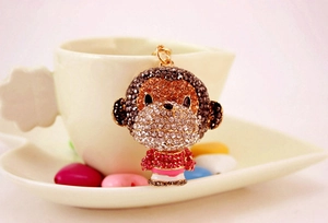 Macro detail of cute alloy monkey keychain with vibrant colorful rhinestones