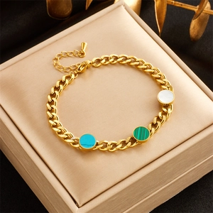 Dettaglio di bracciale a catena dorata con inserti circolari blu e verdi su custodia