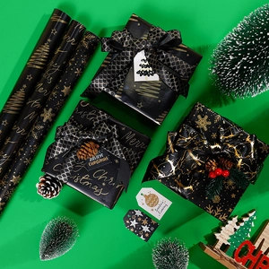 Elegant black and gold Christmas wrapping paper set with snowflakes and festive gift boxes