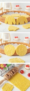 Close-up of wooden Christmas rolling pin with reindeer and snowflake embossed patterns
