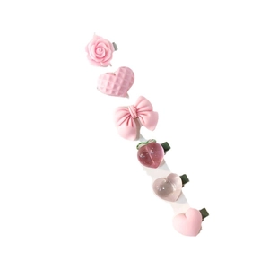 Set of 6 sweet pink hair clips featuring rose, heart, bow, and peach designs on white background
