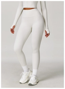 Close-up of cream high-waisted yoga leggings and long sleeve top with thumbholes