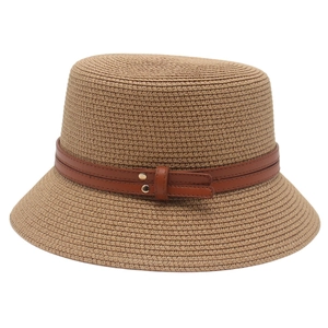 Minimalist straw bucket hat in dark khaki with brown leather straps and gold rivets