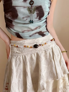 Detail of bohemian waist chain with acrylic geometric beads and hand-woven vintage rope
