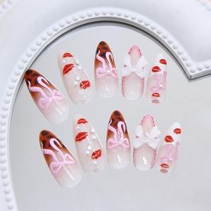 Handmade leopard print press-on nails with 3D white bows and pearl accents for women
