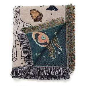 Close-up of bohemian camping blanket showing double-sided jacquard weave and colorful fringes