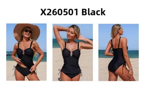Detail view of black tankini with U-shaped metal decor and side drawstring bikini bottom