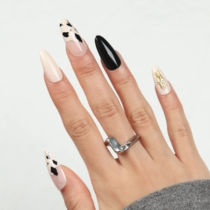 Polished silver V-shaped asymmetric ring with three small inlaid white gemstones