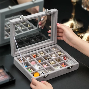 Grey velvet jewelry organizer with glass lid and compartments for rings and earrings