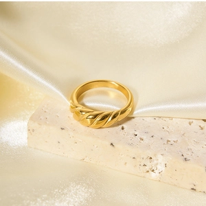 Detailed view of 18k gold plated croissant ring on cream stone and champagne silk