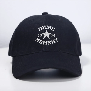 Classic black cotton baseball cap featuring white IN THE MOMENT embroidery in a front view