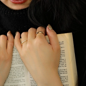 S925 sterling silver 18K gold gradient zircon ring set worn by model on book background