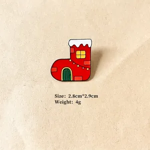 Detailed view of Christmas boot enamel pin measuring 2.8cm by 2.9cm and weighing 4g