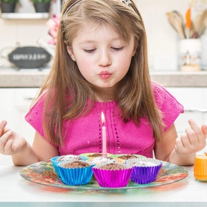 Metallic aluminum foil muffin liners in vibrant blue and purple for baking cupcakes