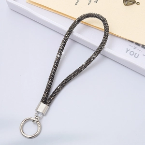 Detail of luxury rhinestone wrist strap with gunmetal crystals and silver snap hook