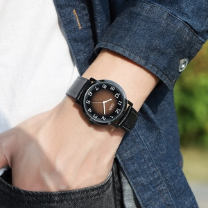 Men's retro quartz watch with black leather strap and brown gradient dial on wrist
