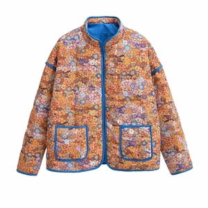 Detailed view of floral quilted jacket with vintage pattern and blue contrast piping