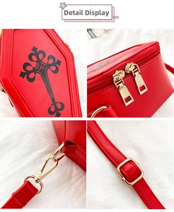 Detailed view of the red coffin bag's Gothic cross print, gold zippers, and strap buckles