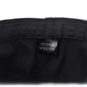 Detailed macro view of the inner lining and 100% polyester fabric care label on the cap