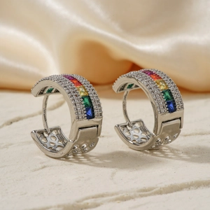 Rainbow zircon micro-pave silver earrings on elegant silk and marble background