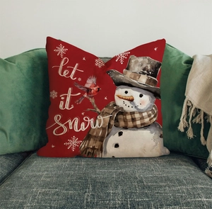 Detail of red Christmas pillowcase with snowman illustration and Let it Snow lettering