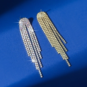 Macro top view of long tassel rhinestone earrings showing front and gold base details