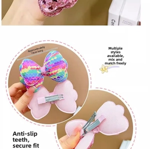 Detail view of a 10cm colorful sequin bow hair clip with a pink back and metal duckbill clip