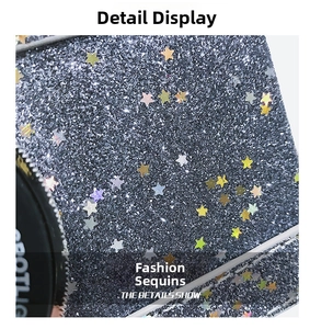 Macro view of silver glitter fabric with colorful star sequins and side circular detail