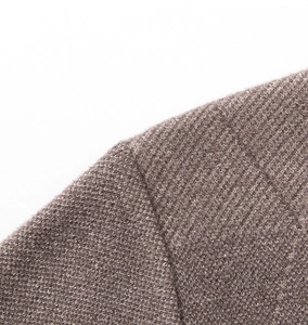 Macro shot showing detail of fine taupe knit texture and high-quality seam stitching