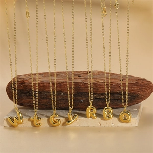 14K gold plated initial letter necklace with puffy balloon pendant on natural stone base