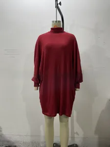 Close-up of wine red loose-fit knit dress featuring a turtle neck and ribbed texture