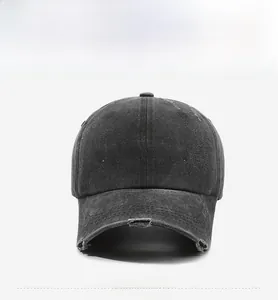 Detail of washed cotton baseball cap featuring white Fragrance embroidery and distressed brim