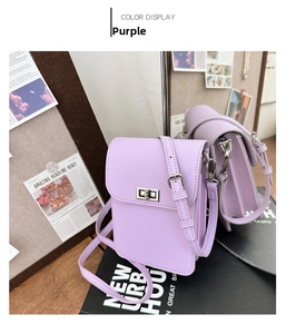 Detail of purple crossbody phone bag showing the silver turn-lock and accordion side panels