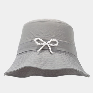 Close-up of pearl bow decoration on a grey quick-dry sun hat for summer outdoor wear