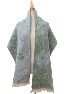 Close-up of blue and green plush scarf with jacquard floral pattern and short fringes