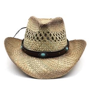 Detail of straw cowboy hat featuring turquoise bead on leather band and wind rope